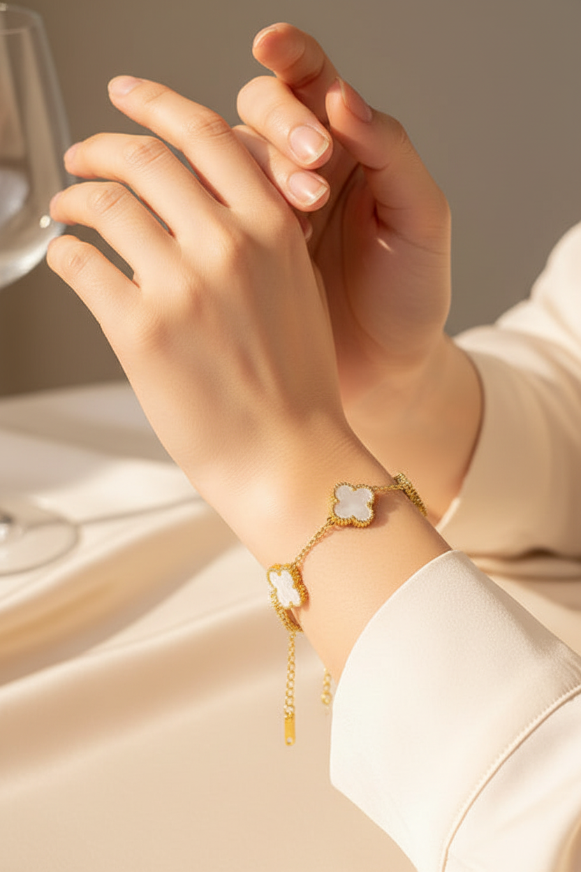 Close-up of gold clover bracelet on wrist